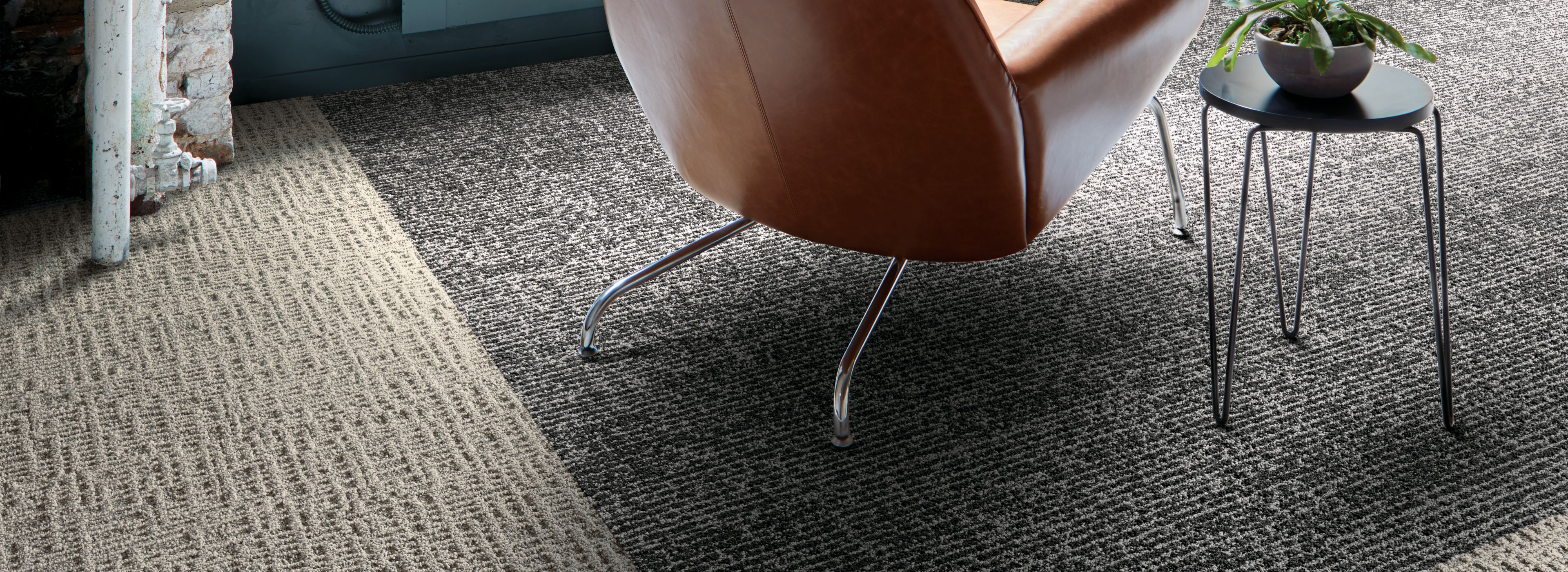 Interface Brownstone and Classic Seven plank carpet tile in seating area with large windows and concrete walls imagen número 1